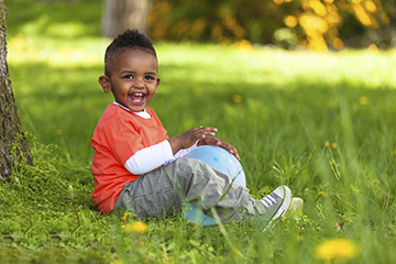 boy sitting on the grass